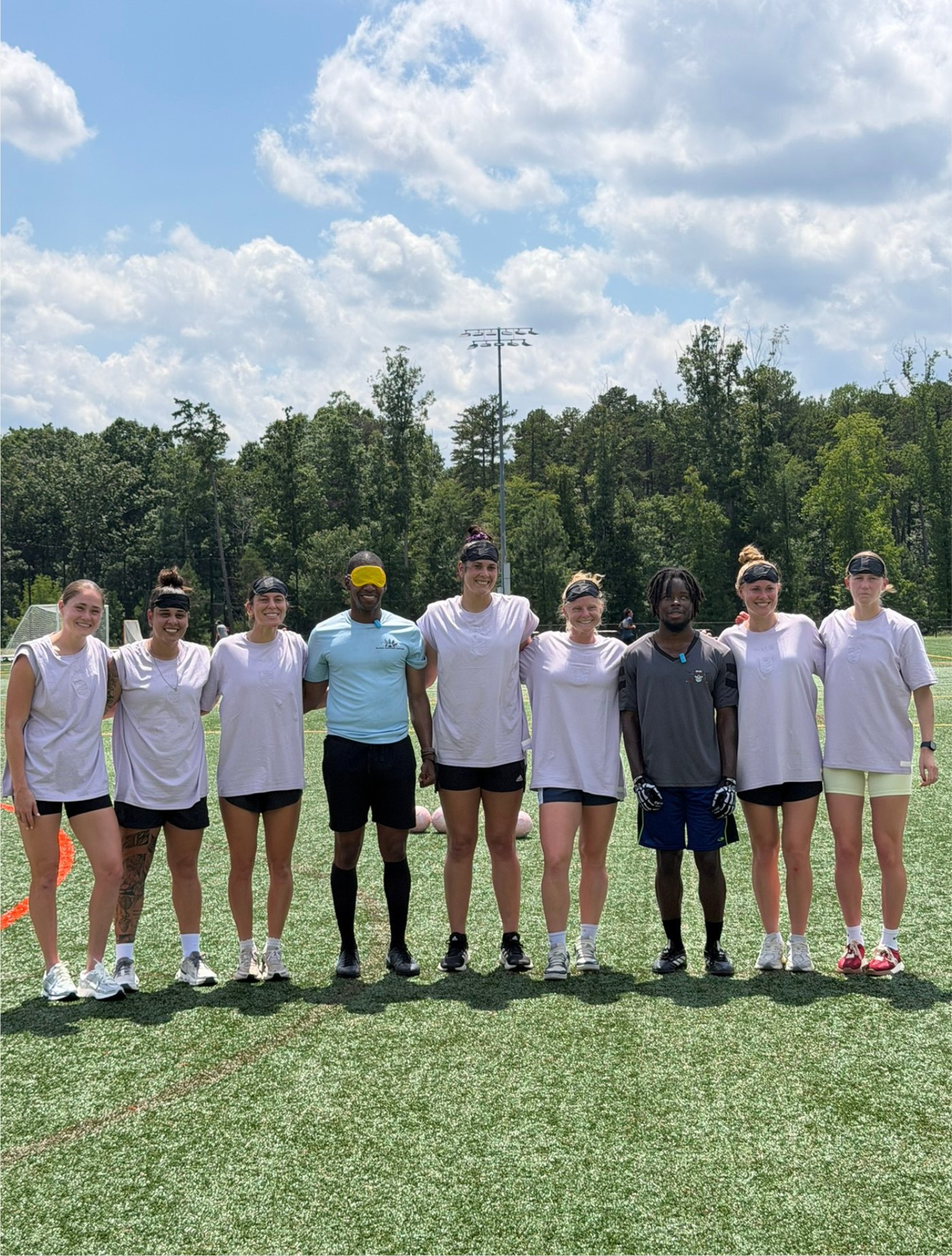 Team photo on the turf: Antoine Craig stands with Carolina Ascent and Blind Soccer Nation athletes in a line after training.